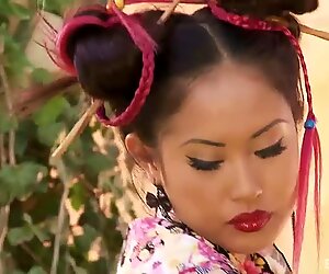 A red hot Japanese girl dressed in costume fingering her pussy