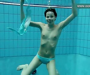 Podvodkova swimming in blue bikini in the pool